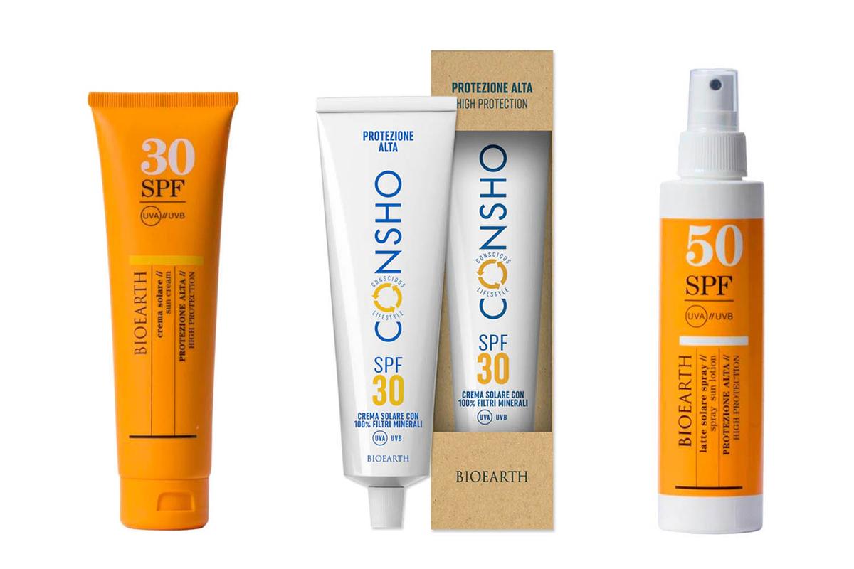 Eine orange Sonnencreme-Tube, eine weiße Sonnencreme und ein oranges Sonnenschutz-Spray von Bioearth