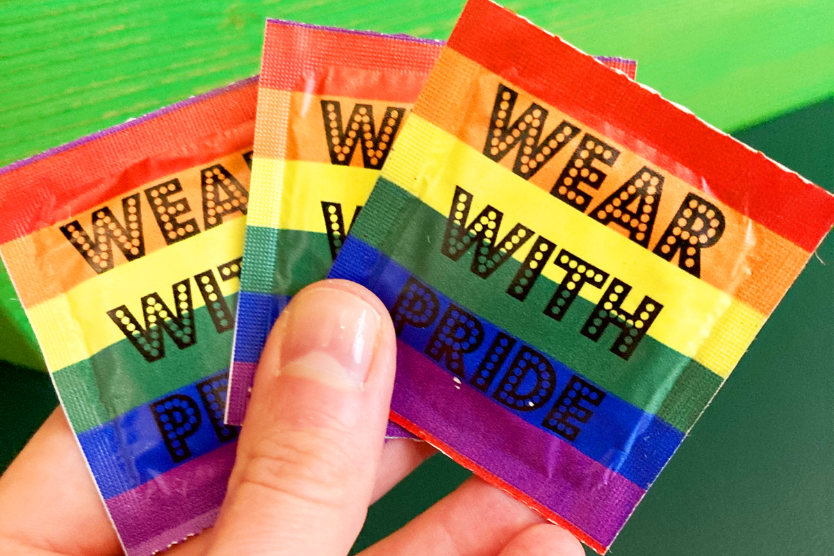 Drei Kondome mit der Aufschrift "Wear with Pride"